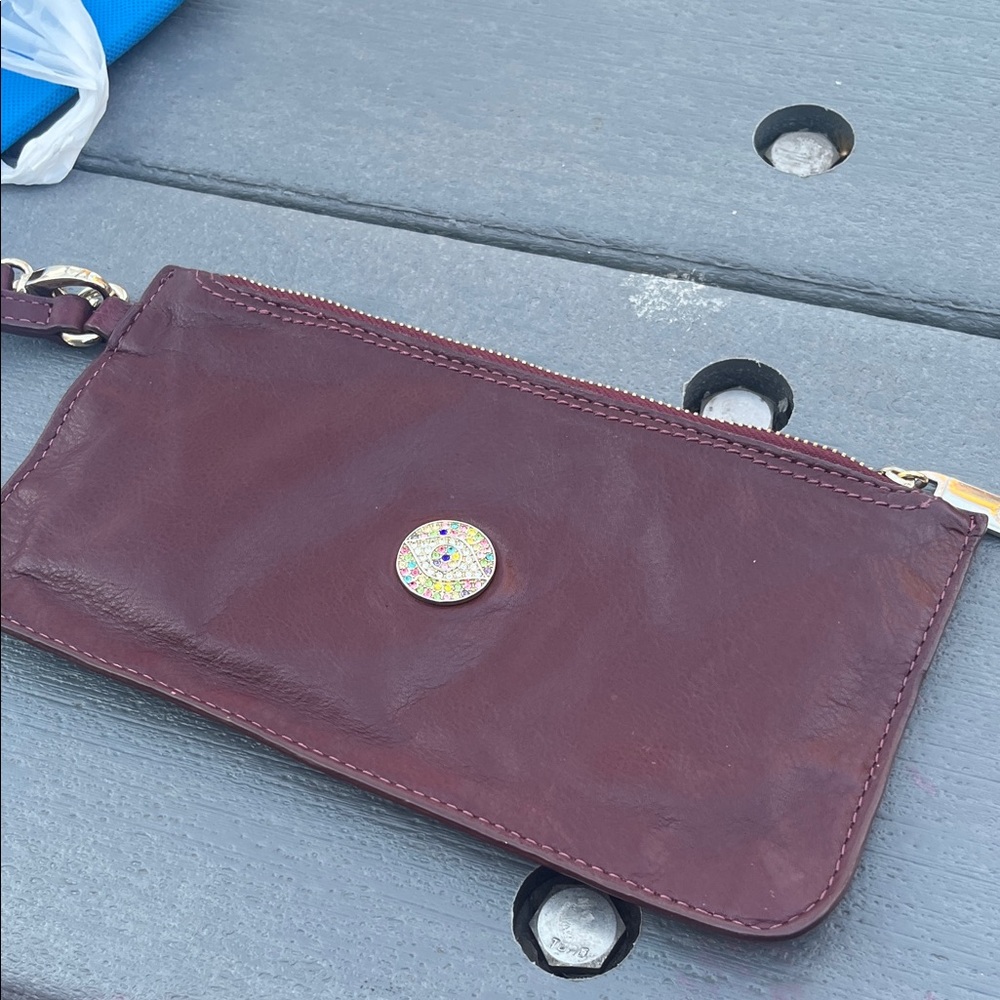 Burgundy Leather Wristlet with Decorative Medallion